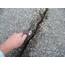 Cleaning an asphalt crack with a five-in-one tool